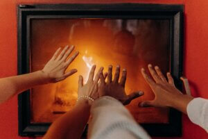 hands in front of a fireplace